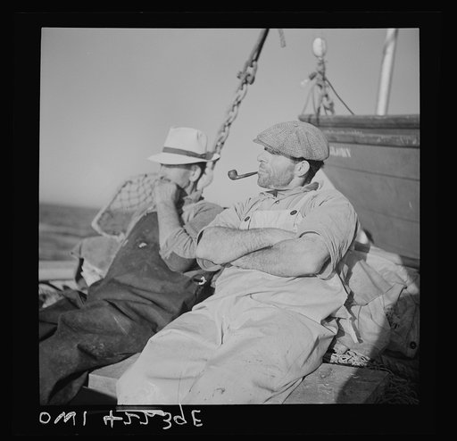 On board a fishing vessel out from Gloucester, Massachusetts. Two fishermen