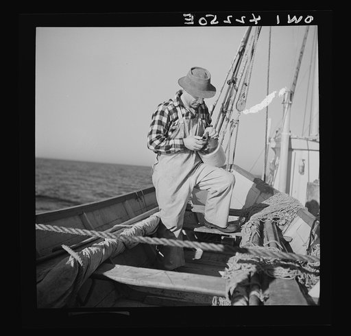 On board a fishing vessel out from Gloucester, Massachusetts. A dory fisherman checking up on his water supply