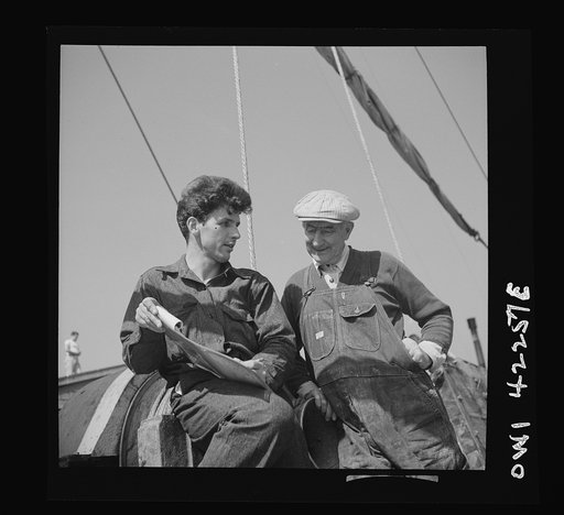 On board a fishing vessel out from Gloucester, Massachusetts. Looking over the record of the day's unloading of fish