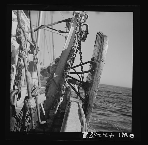 On board a fishing vessel, out from Gloucester, Massachusetts. The two otter boards which work against the current and keep the net open