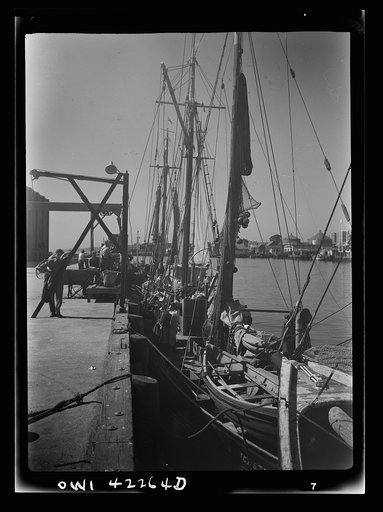 Gloucester, Massachusetts. At the docks crew members prepare their trawlers for a week's voyage. Most of the fishermen come from a line of fishermen that dates back for centuries
