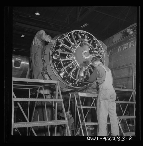 Seattle, Washington. Boeing aircraft plant. Production of B-17F (Flying Fortress) bombing planes. Workers assembling a motor for a B-17F (Flying Fortress) bombers