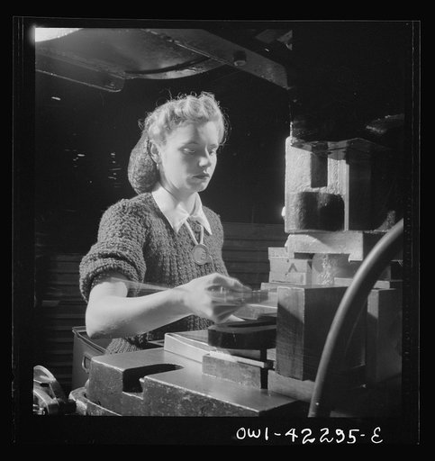 Seattle, Washington. Boeing aircraft plant. Production of B-17F (Flying Fortress) bombing planes. Girl working on a machine