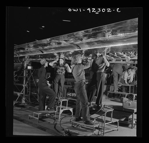 Seattle, Washington. Boeing aircraft plant. Production of B-17F (Flying Fortress) bombing planes. A crew working on the assembly of a wing
