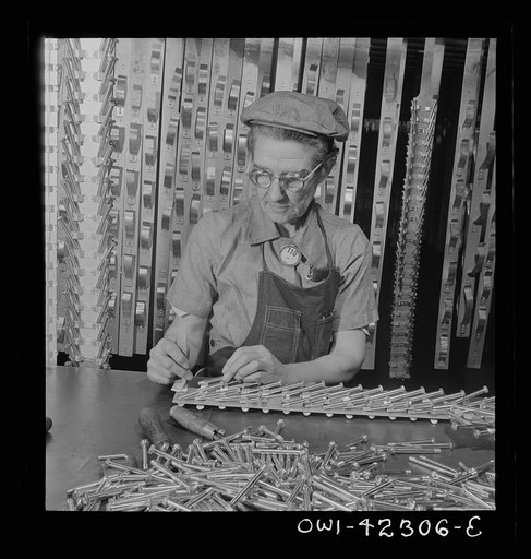 Boeing aircraft plant, Seattle, Washington. Production of B-17F (Flying Fortress) bombing planes. Machine screws to be used in building a B-17F (Flying Fortress) are attached to hangers which suspend them in anodizing tanks. In the tanks they receive a protective plating to prevent corrosion