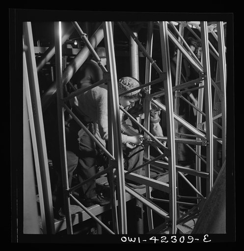Boeing aircraft plant, Seattle, Washington. Production of B-17F (Flying Fortress) bombing planes. Women working on the fuselage framework
