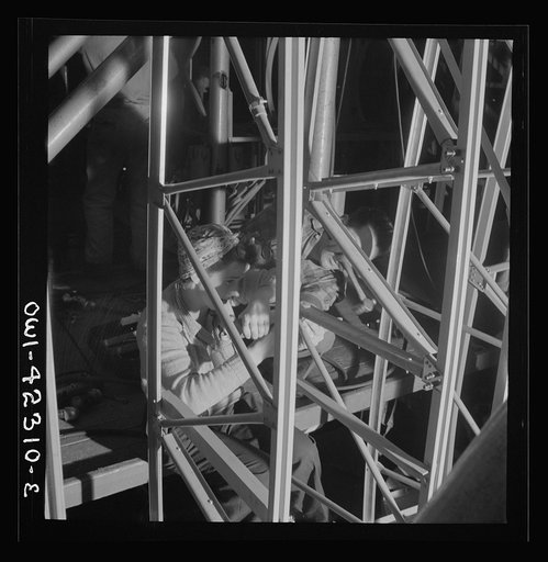 Boeing aircraft plant, Seattle, Washington. Production of B-17F (Flying Fortress) bombing planes. Women working on the fuselage framework