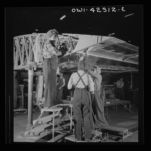 Boeing aircraft plant, Seattle, Washington. Production of B-17F (Flying Fortress) bombing planes. Women assembling a wing