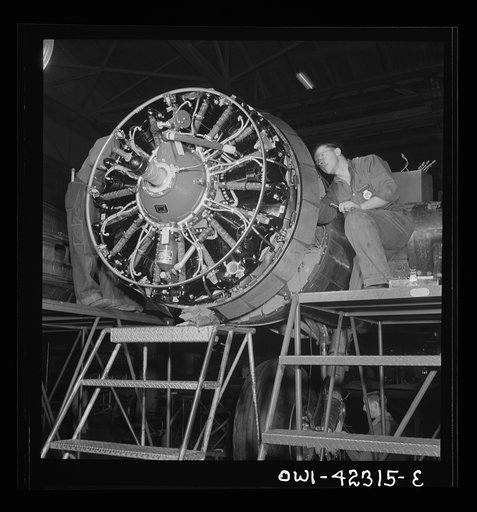 Boeing aircraft plant, Seattle, Washington. Production of B-17F (Flying Fortress) bombing planes. Workers assembling a motor