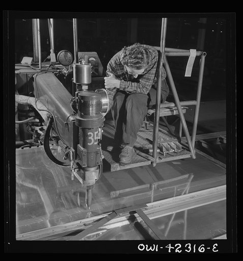 Boeing aircraft plant, Seattle, Washington. Production of B-17F (Flying Fortress) bombing planes. A spot welder