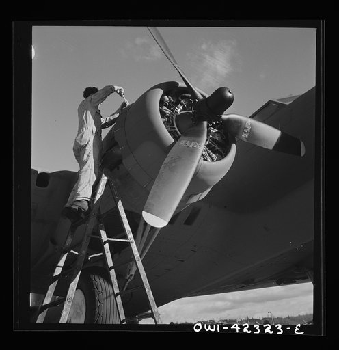 Untitled photo, possibly related to: Boeing aircraft plant, Seattle, Washington. Production of B-17F (Flying Fortress) bombing planes. Lubricating and servicing a new B-17F (Flying Fortress) bombers.