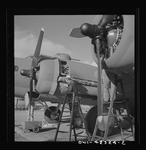 Untitled photo, possibly related to: Boeing aircraft plant, Seattle, Washington. Production of B-17F (Flying Fortress) bombing planes. Lubricating and servicing a new B-17F (Flying Fortress) bombers.