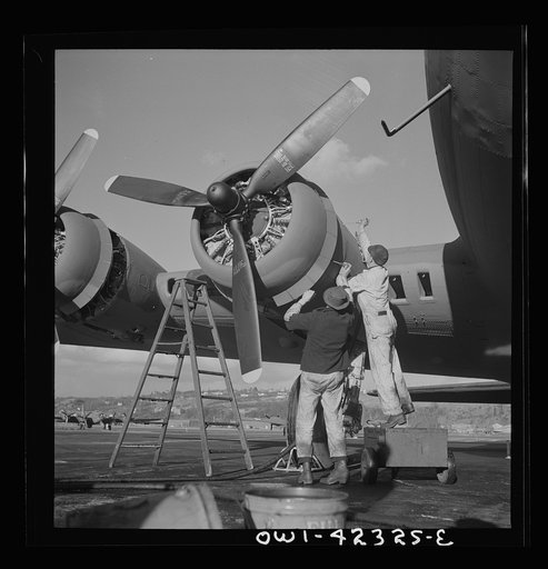 Untitled photo, possibly related to: Boeing aircraft plant, Seattle, Washington. Production of B-17F (Flying Fortress) bombing planes. Lubricating and servicing a new B-17F (Flying Fortress) bombers.