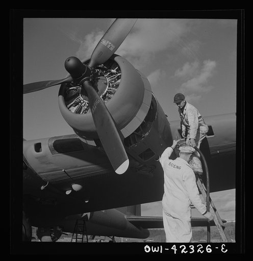 Untitled photo, possibly related to: Boeing aircraft plant, Seattle, Washington. Production of B-17F (Flying Fortress) bombing planes. Lubricating and servicing a new B-17F (Flying Fortress) bombers.