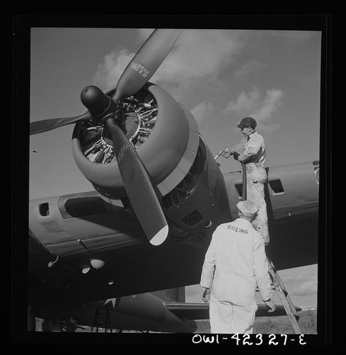 Untitled photo, possibly related to: Boeing aircraft plant, Seattle, Washington. Production of B-17F (Flying Fortress) bombing planes. Lubricating and servicing a new B-17F (Flying Fortress) bombers.