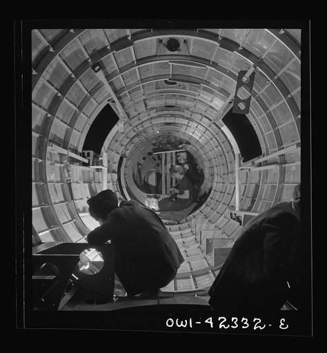 Untitled photo, possibly related to: Boeing aircraft plant, Seattle, Washington. Production of B-17F (Flying Fortress) bombing planes. A crew working in a nearly completed fuselage section
