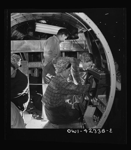 Untitled photo, possibly related to: Boeing aircraft plant, Seattle, Washington. Production of B-17F (Flying Fortress) bombing planes. A crew working in a nearly completed fuselage section