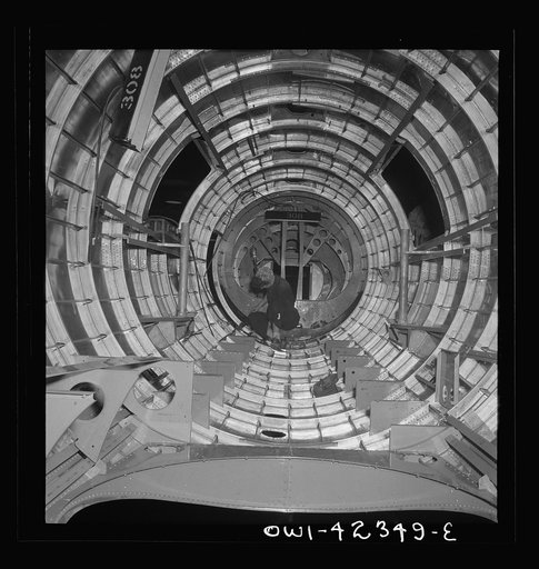 Untitled photo, possibly related to: Boeing aircraft plant, Seattle, Washington. Production of B-17F (Flying Fortress) bombing planes. A crew working in a nearly completed fuselage section
