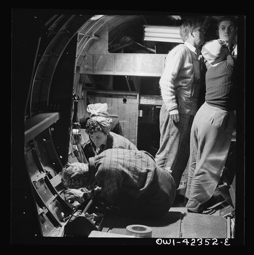 Untitled photo, possibly related to: Boeing aircraft plant, Seattle, Washington. Production of B-17F (Flying Fortress) bombing planes. A crew working in a nearly completed fuselage section