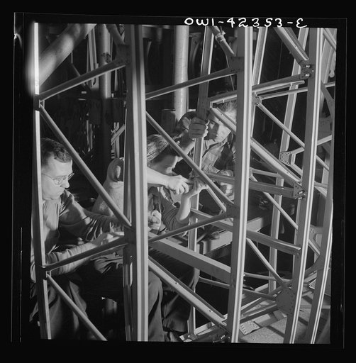 Untitled photo, possibly related to: Boeing aircraft plant, Seattle, Washington. Production of B-17F (Flying Fortress) bombing planes. Women working on the fuselage framework