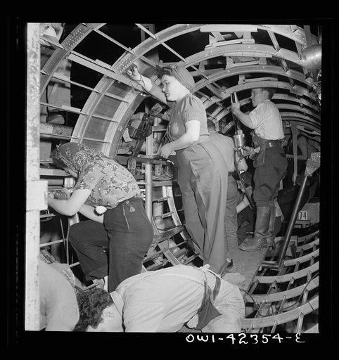 Untitled photo, possibly related to: Boeing aircraft plant, Seattle, Washington. Production of B-17F (Flying Fortress) bombing planes. A crew working in a nearly completed fuselage section