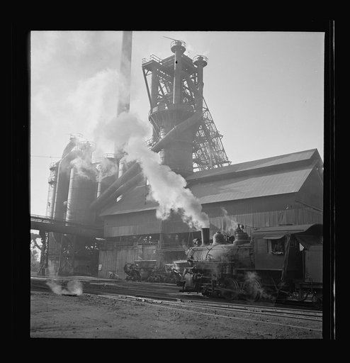 Columbia Steel Company at Ironton, Utah. A locomotive outside the blast furnace