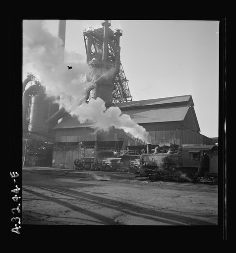 Untitled photo, possibly related to: Columbia Steel Company at Ironton, Utah. A locomotive outside the blast furnace