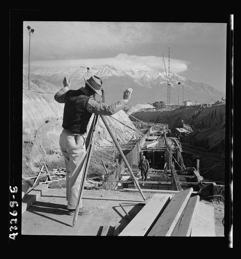 Untitled photo, possibly related to: Columbia Steel Company at Geneva, Utah. Surveyor running lines for a water intake tunnel to serve a new steel mill under construction which will make important additions to the vast amount of steel needed for the war effort