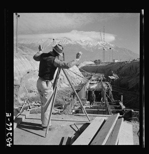 Columbia Steel Company at Geneva, Utah. Surveyor running lines for a water intake tunnel to serve a new steel mill under construction which will make important additions to the vast amount of steel needed for the war effort