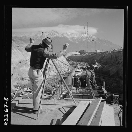 Untitled photo, possibly related to: Columbia Steel Company at Geneva, Utah. Surveyor running lines for a water intake tunnel to serve a new steel mill under construction which will make important additions to the vast amount of steel needed for the war effort