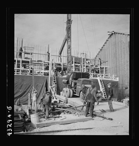 Columbia Steel Company at Geneva, Utah. Setting a pipe with a derrick during the construction of a new steel mill which will make important additions to the vast amount of steel needed for the war effort