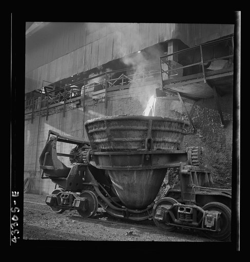 Columbia Steel Company at Ironton, Utah. Tapping a blast furnace for an iron cast