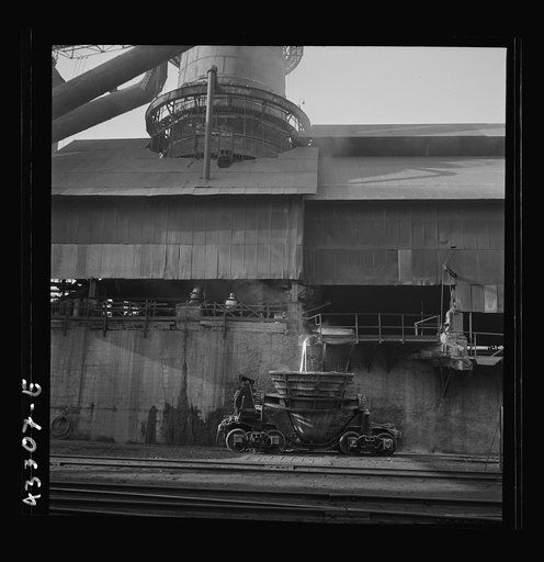Columbia Steel Company at Ironton, Utah. Tapping a blast furnace for an iron cast