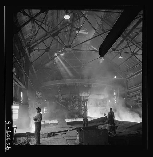 Columbia Steel Company at Ironton, Utah. Tapping a heat of iron in the cast house of the blast furnace