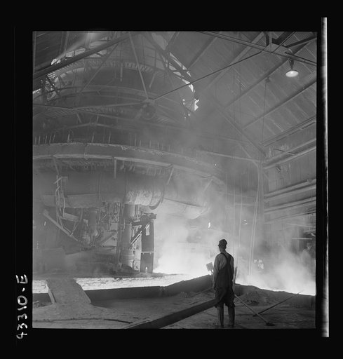 Untitled photo, possibly related to: Columbia Steel Company at Ironton, Utah. Tapping a heat of iron in the cast house of the blast furnace