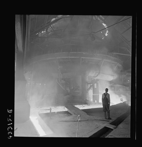 Columbia Steel Company at Ironton, Utah. Tapping a heat of iron in the cast house of the blast furnace