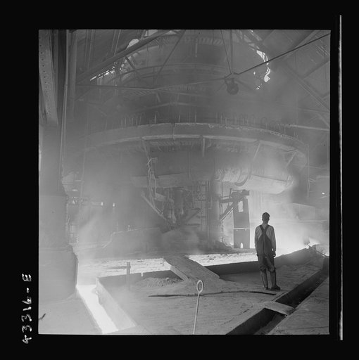 Untitled photo, possibly related to: Columbia Steel Company at Ironton, Utah. Tapping a heat of iron in the cast house of the blast furnace