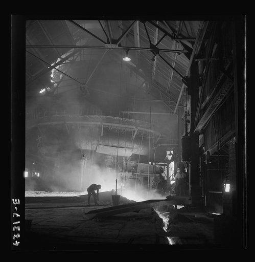 Untitled photo, possibly related to: Columbia Steel Company at Ironton, Utah. Tapping a heat of iron in the cast house of the blast furnace