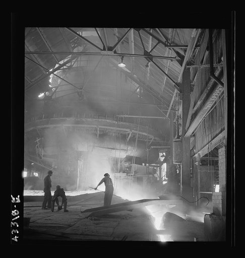 Columbia Steel Company at Ironton, Utah. Tapping a heat of iron in the cast house of the blast furnace