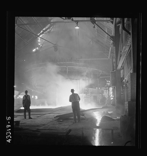 Columbia Steel Company at Ironton, Utah. Tapping a heat of iron in the cast house of the blast furnace
