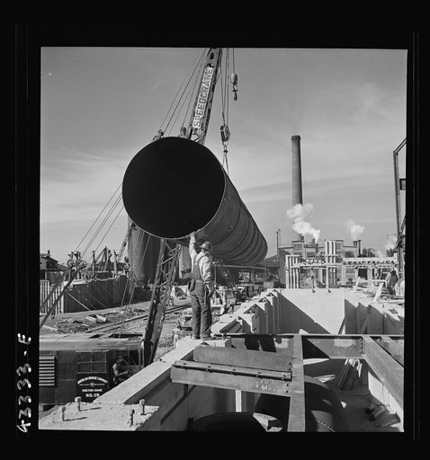 Columbia Steel Company at Geneva, Utah. Setting a pipe with a derrick during the construction of a new steel mill which will make important additions to the vast amount of steel needed for the war effort