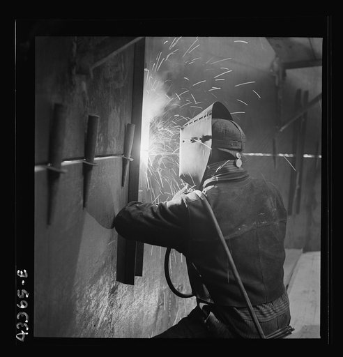 Untitled photo, possibly related to: Columbia Steel Company at Geneva, Utah. An electric arc welder helping in the construction of a new steel mill which will make important additions to the vast amount of steel needed for the war effort