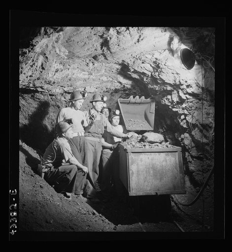 New Idria, California. Loading cinnabar, an ore containing mercury and sulphur, into a mine car with a mechanical loader. Triple-distilled mercury is produced from the ore at the New Idria Quicksilver Mining Company