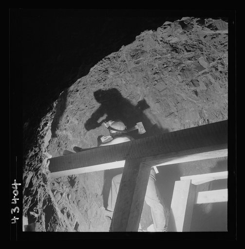 New Idria, California. A workman of the timbering crew setting new supports at the mercury mine of the New Idria Quicksilver Mining Company where cinnabar, an ore containing sulphur and mercury is obtained