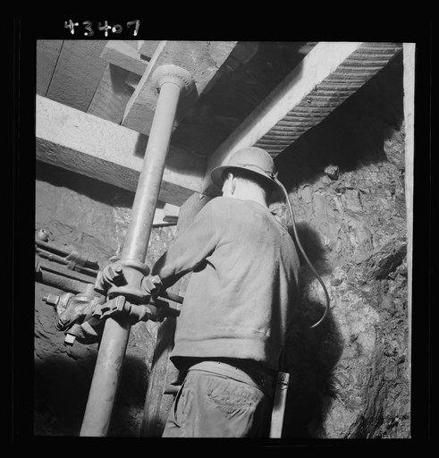 New Idria, California. Drilling blast holes with a compressed-air rock drill in one of the workings of the New Idria Quicksilver Mining Company, where cinnabar ore, containing mercury, is obtained