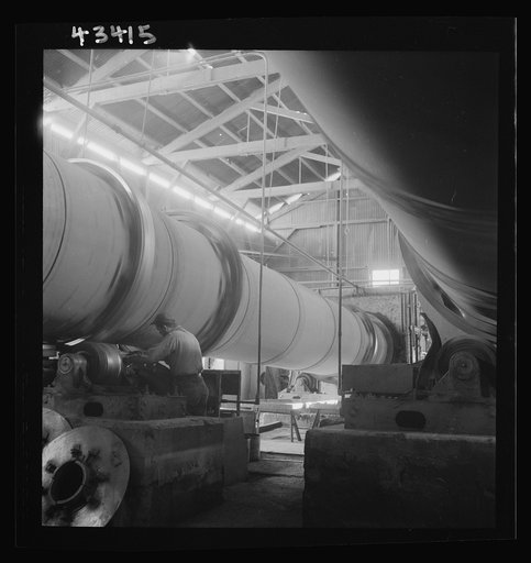 Untitled photo, possibly related to: New Idria, California. A rotary kiln at the mercury extraction plant of the New Idria Quicksilver Mining Company. A 1200 degree Fahrenheit heat drives off the sulphur and vaporizes the mercury which is later condensed