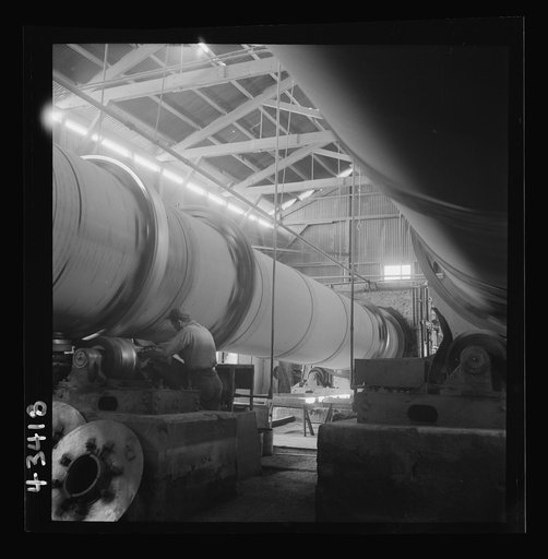 Untitled photo, possibly related to: New Idria, California. A rotary kiln at the mercury extraction plant of the New Idria Quicksilver Mining Company. A 1200 degree Fahrenheit heat drives off the sulphur and vaporizes the mercury which is later condensed