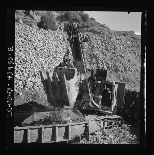 Untitled photo, possibly related to: New Idria, California. Trucks, shovel, and crane used in loading cinnabar, an ore containing mercury, at an open-cut mine of the New Idria Quicksilver Mining Company's workings