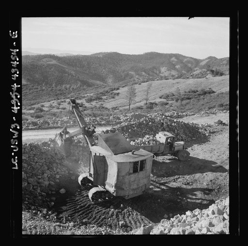 Untitled photo, possibly related to: New Idria, California. Trucks, shovel, and crane used in loading cinnabar, an ore containing mercury, at an open-cut mine of the New Idria Quicksilver Mining Company's workings