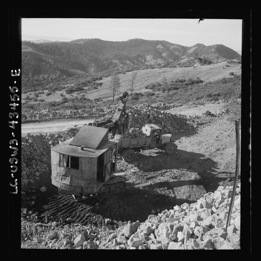 Untitled photo, possibly related to: New Idria, California. Trucks, shovel, and crane used in loading cinnabar, an ore containing mercury, at an open-cut mine of the New Idria Quicksilver Mining Company's workings